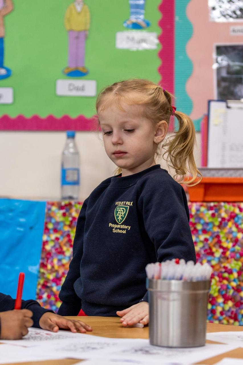 A Reception child engaged in classroom learning at Vita et Pax, North London