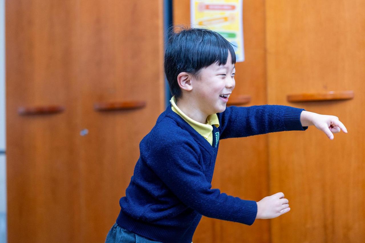 A child laughing during wraparound care at Vita et Pax Preparatory School