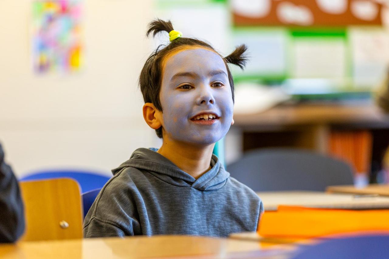 A pupil in fancy dress enjoying World Book Day celebrations in class