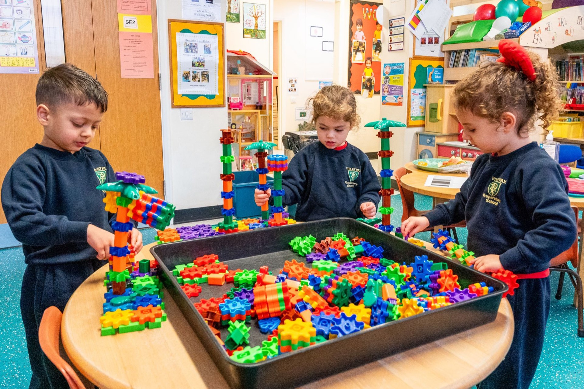 Reception pupils in school uniform engaged in construction play at Vita et Pax Preparatory School, Southgate N14
